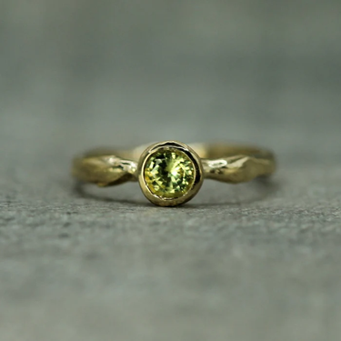 14k Yellow Gold Solitaire ring with a yellow sapphire studded at the top